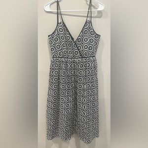 Navy dress with white detailing. Goes below the knees. For fancier occasion